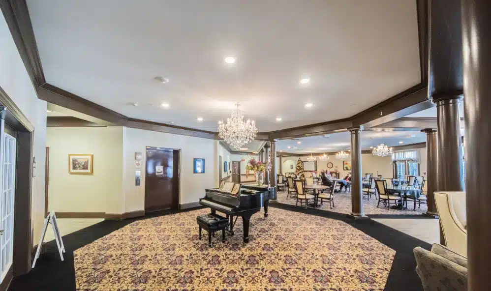 hotel lobby showcasing a chandelier above and a pian
